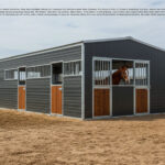 A gray metal portable horse stable with multiple stalls, featuring light wooden doors and a bay horse looking out from one of the openings.