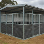 Complete horse property blueprint shelter with fully enclosed galvanized steel frame and weather-resistant panel construction for all-climate protection.