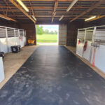 Professional horse infrastructure barn interior featuring galvanized steel stalls, safety flooring and efficient tack storage systems for Australian equine facilities.