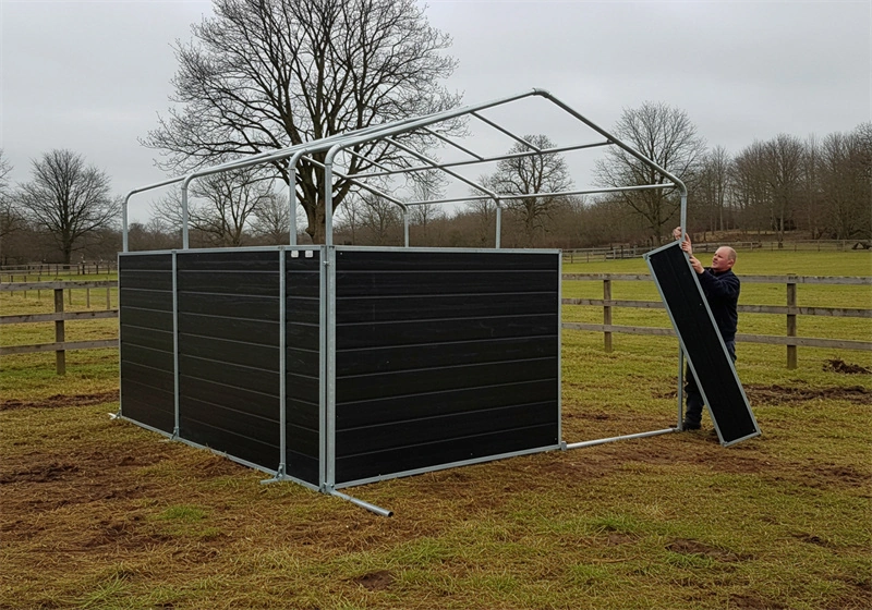 A B2B installation process demonstrating a man erecting a flat-pack stable kit, showcasing the ease of assembly for our Portable Horse Stables for ANZ designed for distributors and equestrian farms.