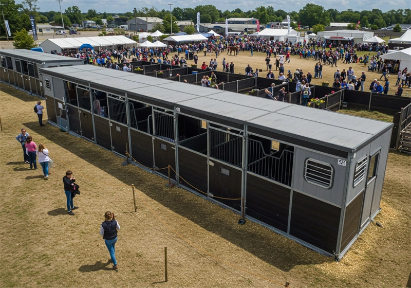 A quadra configuration of portable horse stables showcased at an Australian equestrian event. These durable DIY stable kits feature galvanized steel frames and HDPE boards, designed for professional farm operations in Oceania.