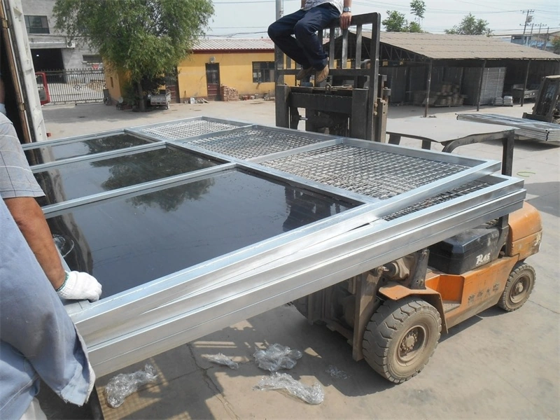 DB Stable factory workers loading prefabricated stable components onto a forklift for export. These heavy-duty portable horse stables for ANZ feature robust hot-dip galvanized steel frames ensuring durability for Australian and New Zealand equestrian facilities.