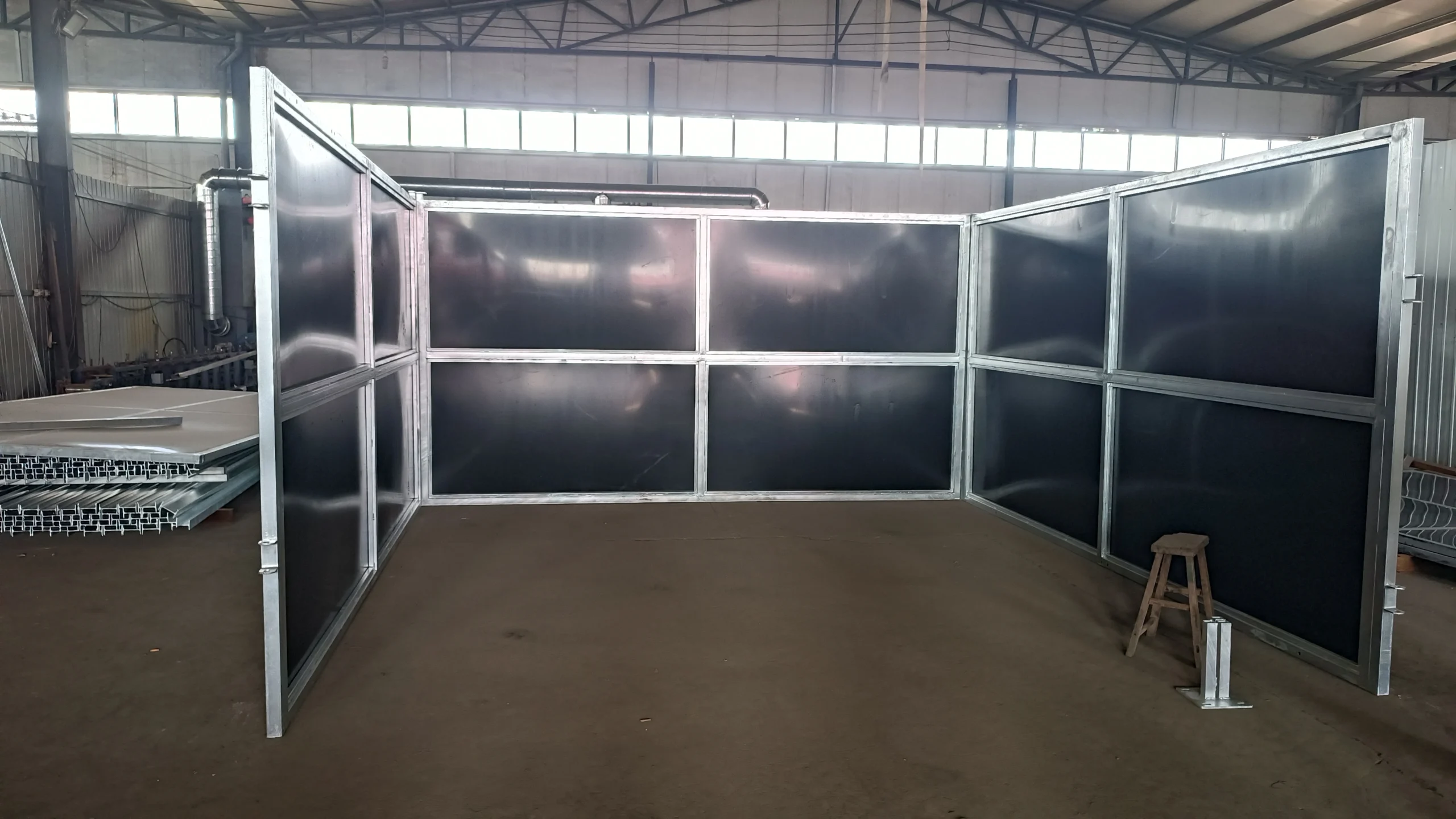 Hot-dip galvanized steel frames and HDPE panels of DB Stable's prefabricated portable horse stables for ANZ are assembled in a factory setting for international shipping. This modular kit design ensures durability and easy installation for professional equestrian centers.